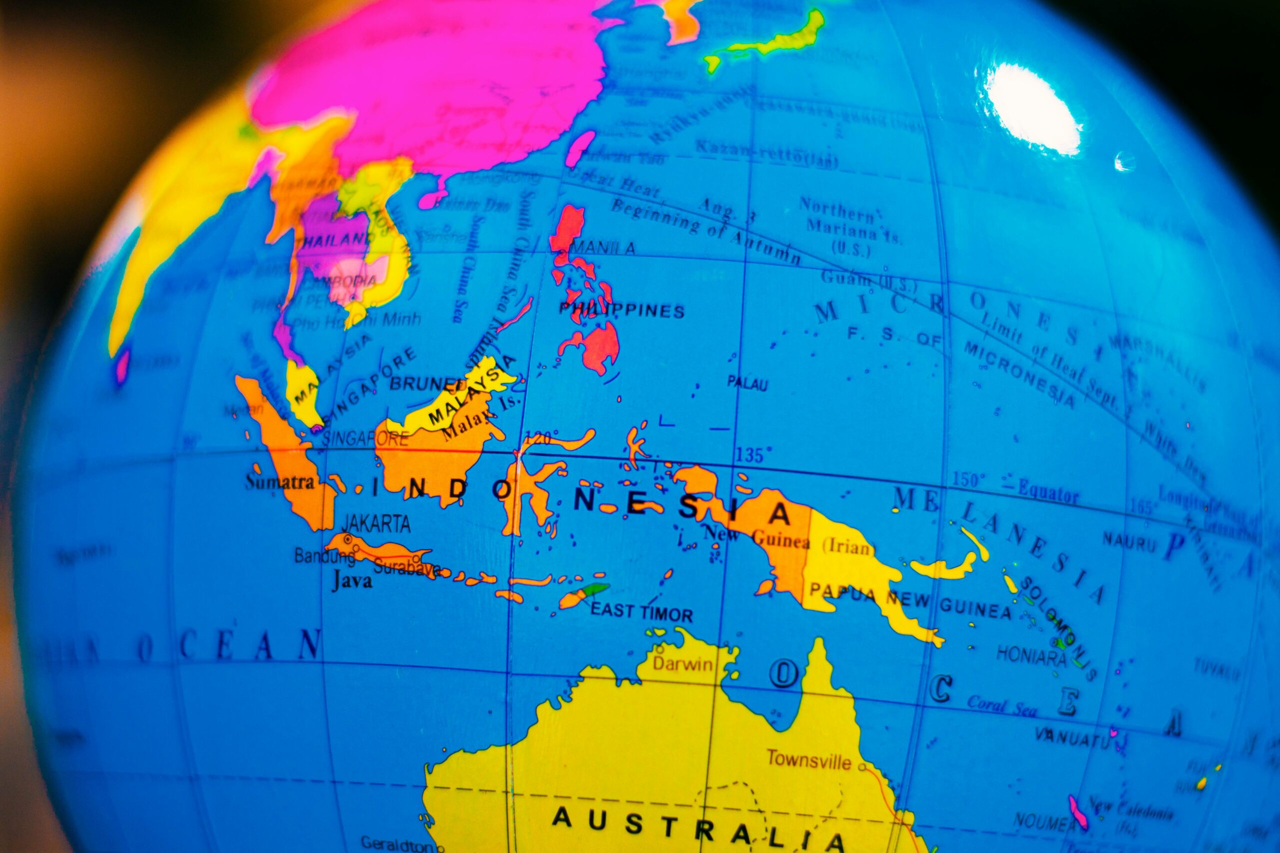 A vibrant globe highlighting Indonesia and surrounding countries in Southeast Asia and Australia.